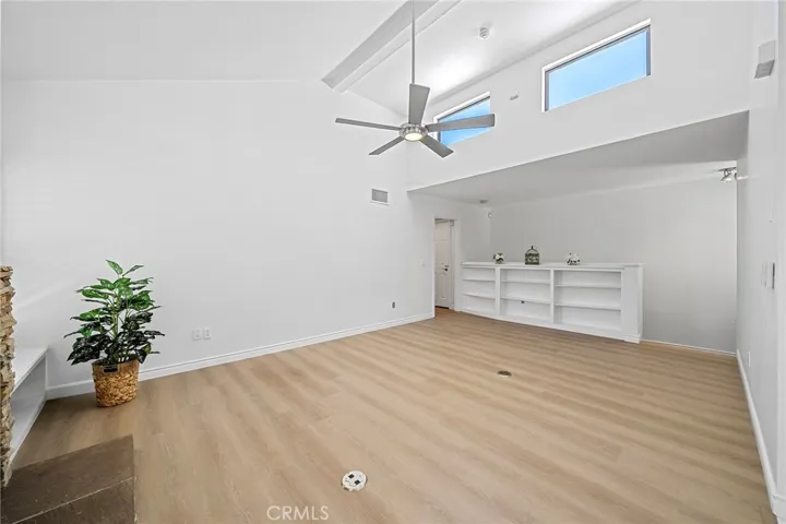 Fresh paint and new flooring. Ready form you to move right in. View from the dining area to stairs to front door and garage.