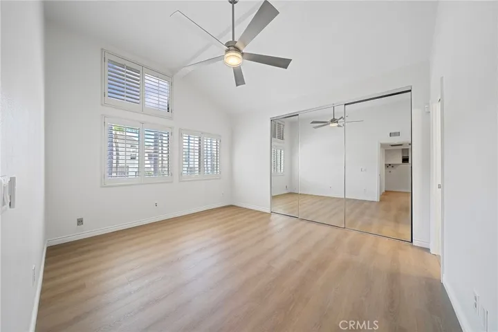 Large main suite with mirrored closet doors.
