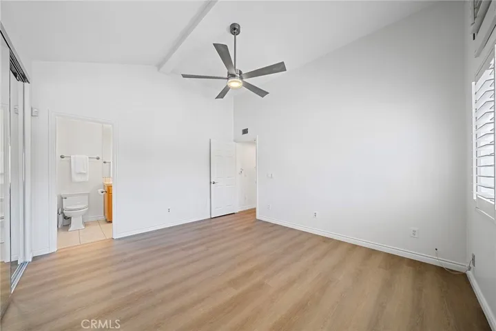 Large main suite has an upgraded bathroom and views of the main pool. New floors and new paint. Plantation shutters throughout. Move-in ready.