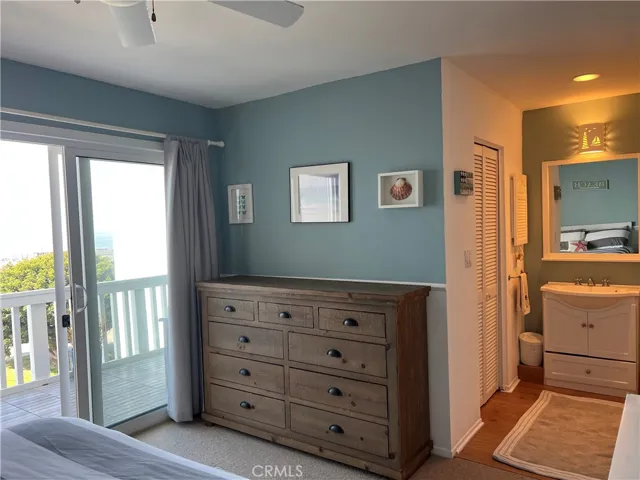 Ocean side bedroom with balcony & private vanity. walk in closet