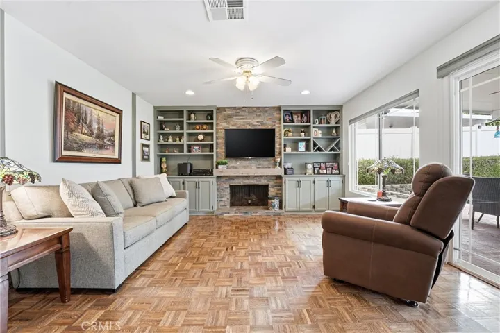 family room off kitchen with matching cabinetry and lots of natural light