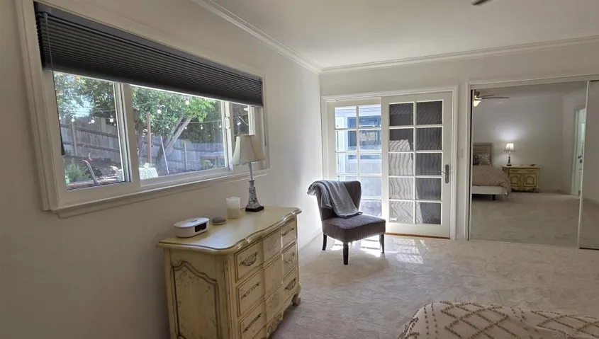 Primary bedroom with french door to backyard