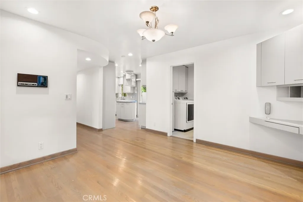 Breakfast nook looking toward convenient laundry room/bathroom combo - perfect for pool days!