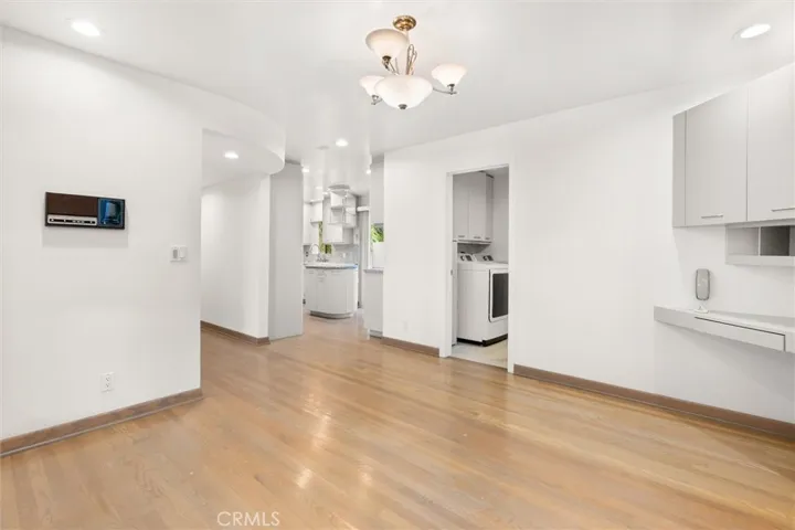 Breakfast nook looking toward convenient laundry room/bathroom combo - perfect for pool days!