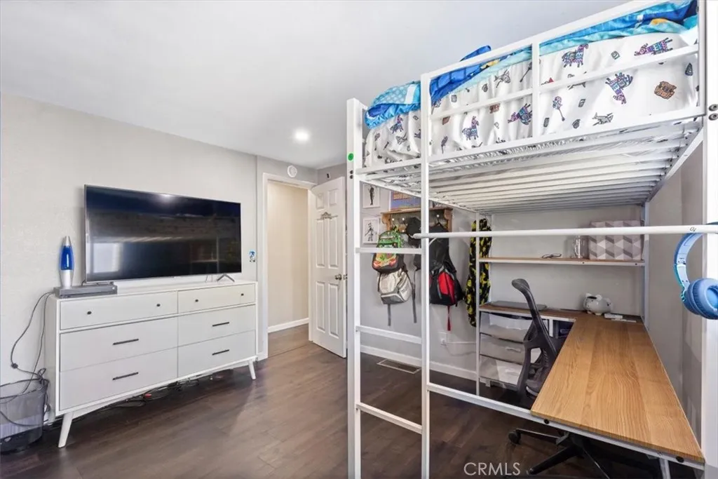 Digitally Enhanced Bedroom: Image has been digitally enhanced to show an alternate neutral wall color for visualization purposes. Original photo shown adjacent.