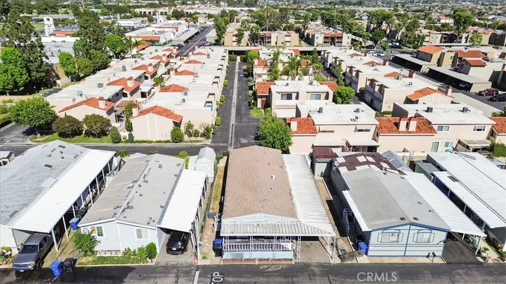 Drone View: Aerial perspective of the home’s location within Lincoln Center Mobile Home Park, an all-age Cypress community near local amenities, shopping, dining, entertainment, and convenient freeway access.