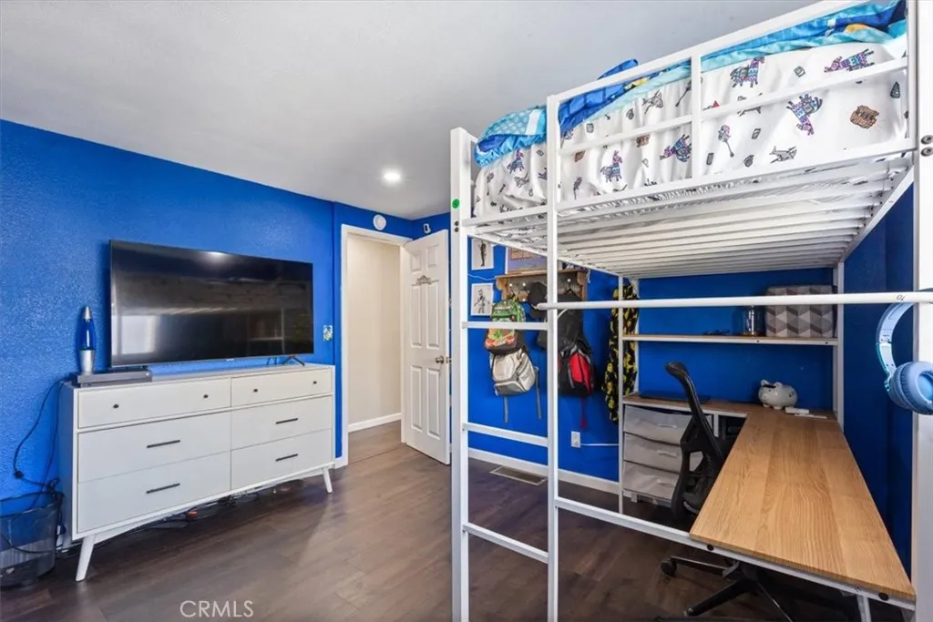 Spacious secondary bedroom with updated flooring, recessed lighting, neutral finishes, and flexible space for sleeping, studying, office use, or storage.