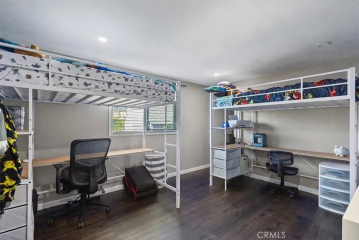 Digitally Enhanced Bedroom: Image has been digitally enhanced to show an alternate neutral wall color for visualization purposes. Original photo shown adjacent.
