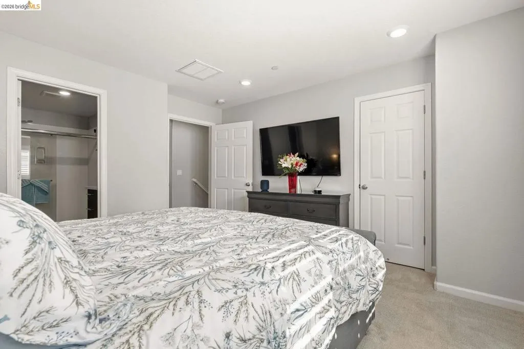 bedroom featuring light colored carpet and recessed lighting