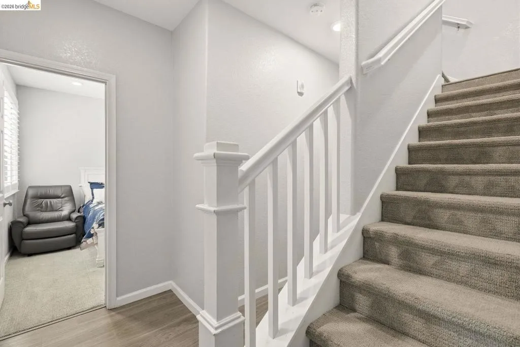 stairway with baseboards and wood finished floors