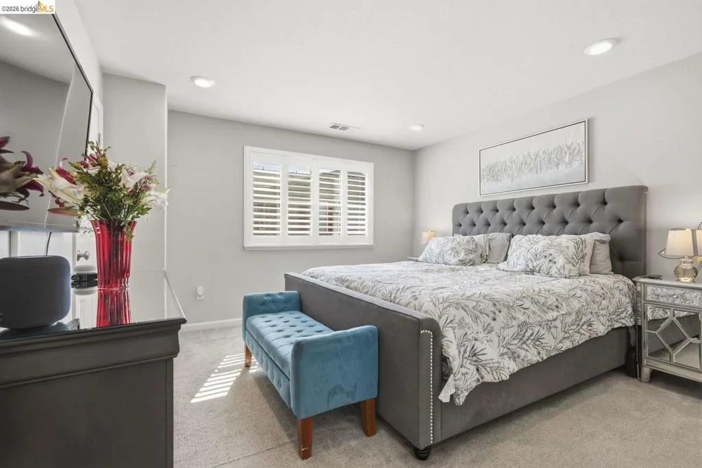 bedroom featuring light carpet and recessed lighting