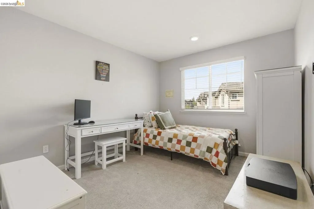 bedroom featuring light carpet