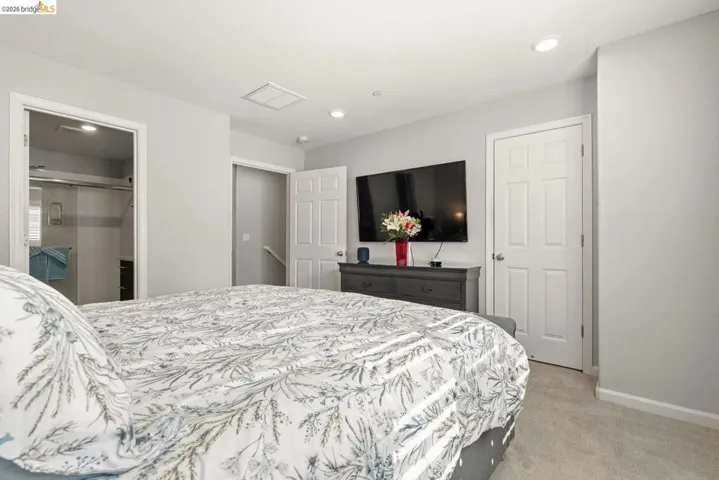 bedroom featuring light colored carpet and recessed lighting