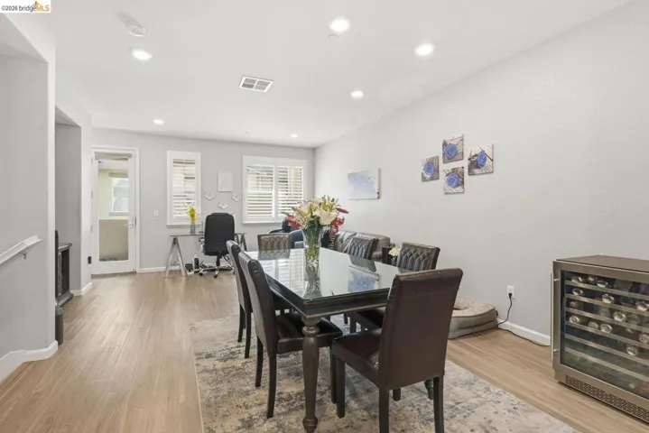 dining room featuring wine cooler, light wood-style flooring, recessed lighting, and a desk