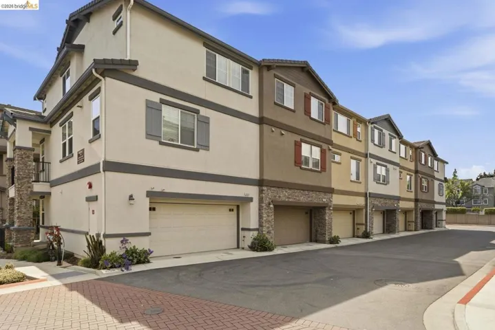 view of building exterior featuring a residential view and driveway