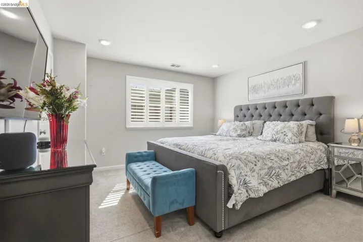 bedroom featuring light carpet and recessed lighting