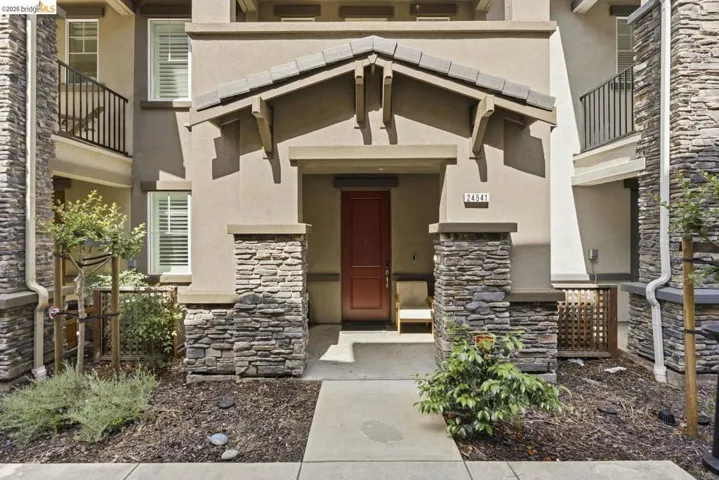 property entrance featuring stone siding and stucco siding