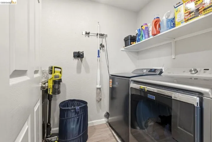laundry area featuring separate washer and dryer and light wood-type flooring