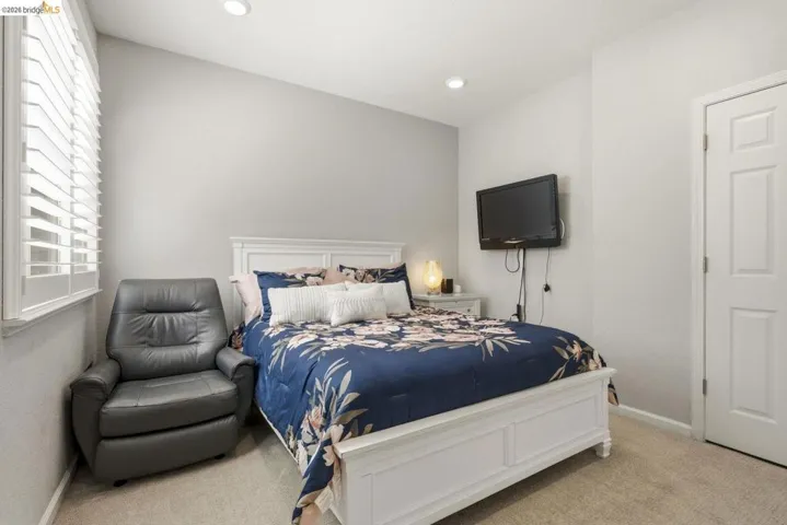 carpeted bedroom with baseboards and recessed lighting