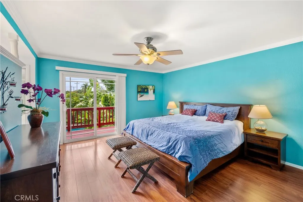 Primary Bedroom sliding glass door opens to the wood deck overlooking the backyard