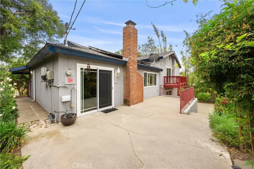 Sliding glass door opens to concrete patio deck from Dining Area overlooking the backyard