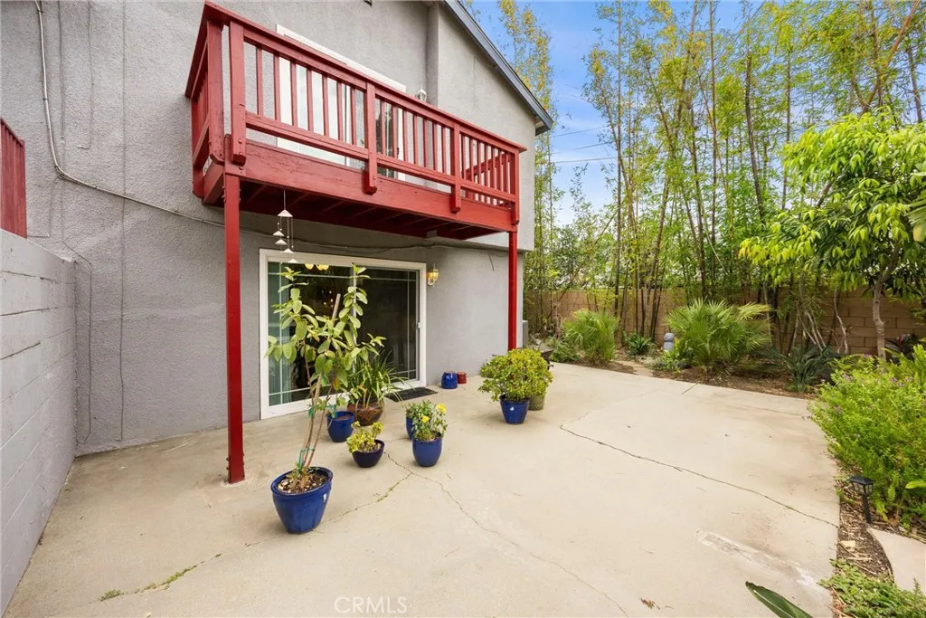 Primary Bedroom's wood deck overlooks backyard