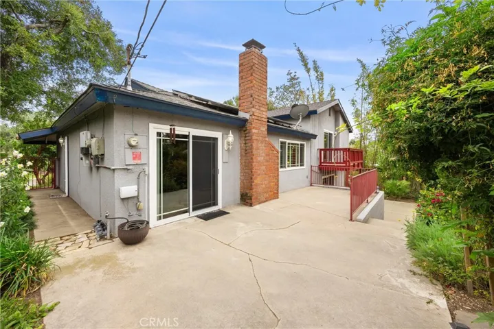 Sliding glass door opens to concrete patio deck from Dining Area overlooking the backyard