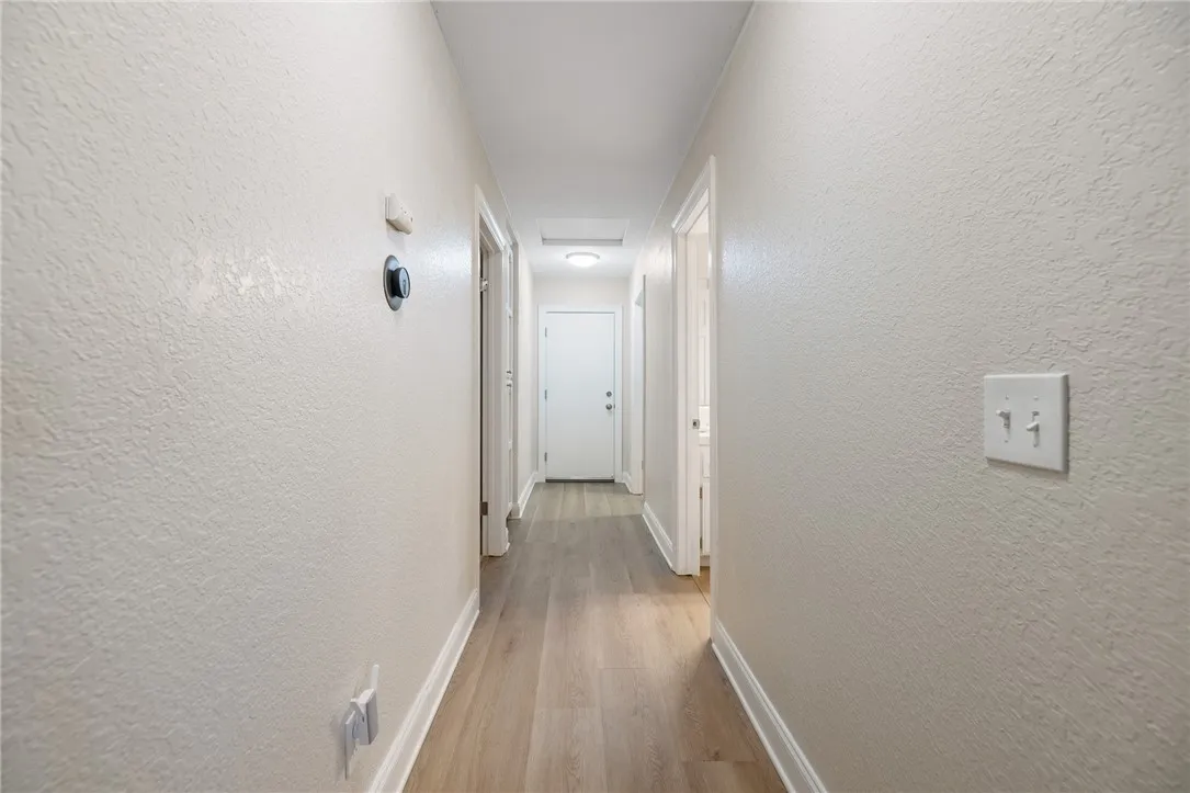 Hall toward Garage.  Bedroom 3 is on the left.  Guest bath on the right. Laundry room on the right