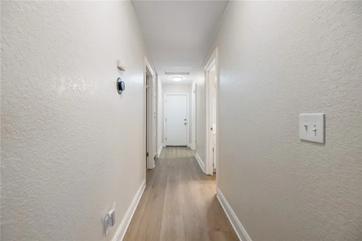 Hall toward Garage.  Bedroom 3 is on the left.  Guest bath on the right. Laundry room on the right
