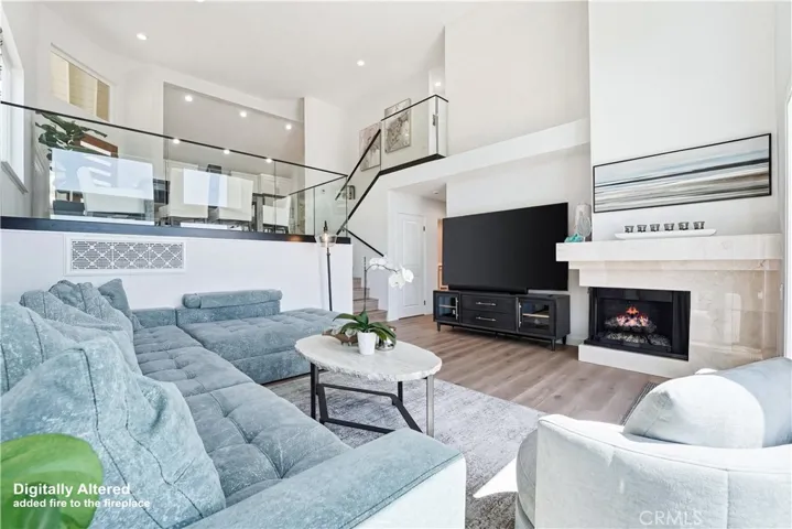 Large great room with fireplace and french doors to expansive yard