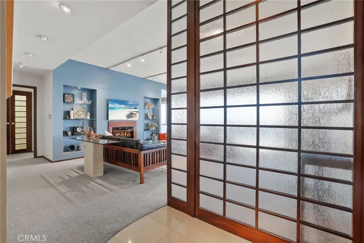 Bespoke wood and frosted glass screen invite you into the relaxing living room