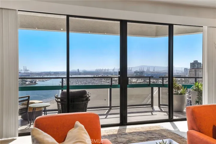 Full length glass sliders open to the peaceful balcony and view of the coastline.