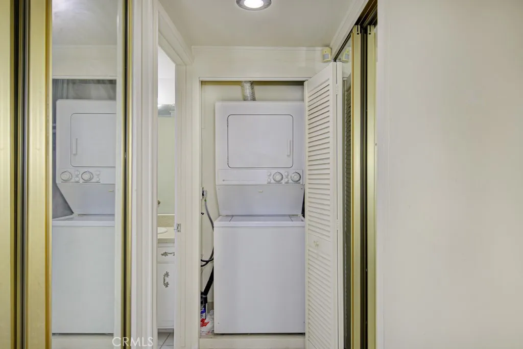 Stackable washer/dryer is conveniently located in a closet in the primary bedroom.