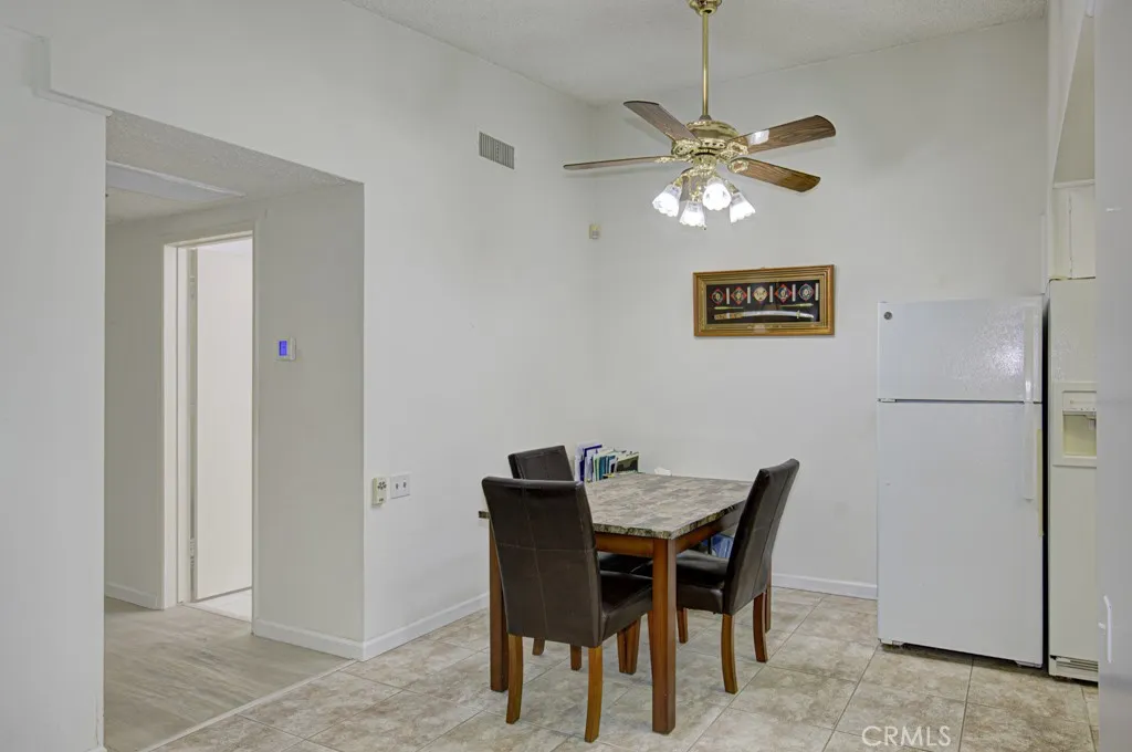 Dining area. Hallway leading to the bedrooms and bathrooms is on the left.