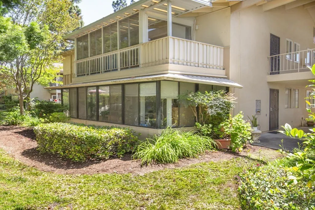 Unit "T" is the upstairs unit in this photo. The balcony has been enclosed with large glass sliders for year-round enjoyment.