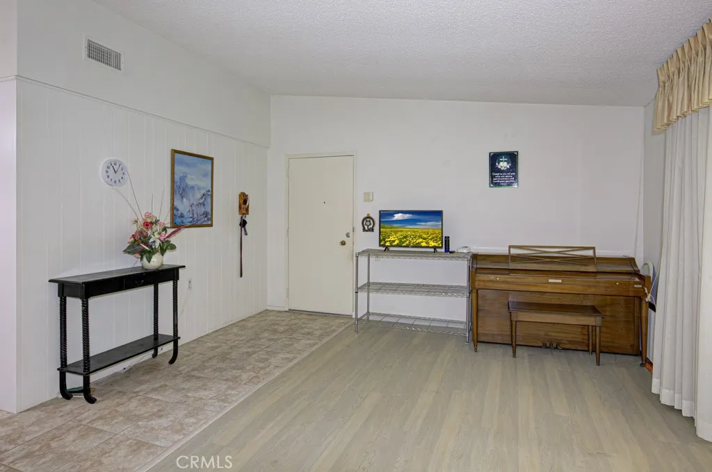 Another view of the living room. Kitchen is behind the wall at left.
