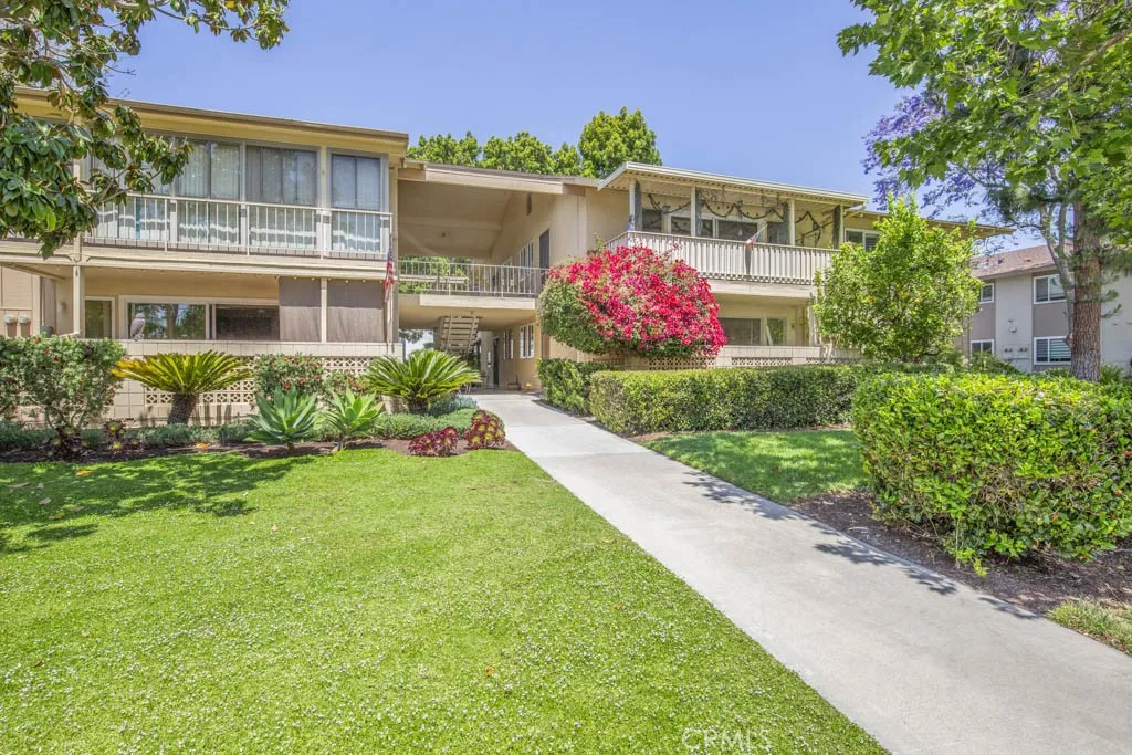 Welcome to 40-T Calle Aragon - a two-bedroom, two-bath CASA BLANCA upstairs residence in the Laguna Woods senior community. Unit "T" is the upstairs unit on the right side rear of this photo. This shot was taken from the sidewalk leading from the nearby carport. Note the immaculate landscaping and lovely curb appeal.