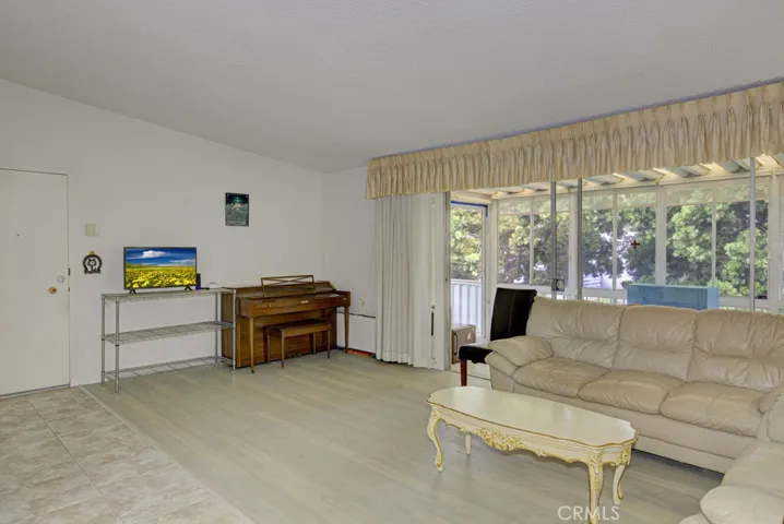 Another view of the living room. Front door can be partially seen at far left.