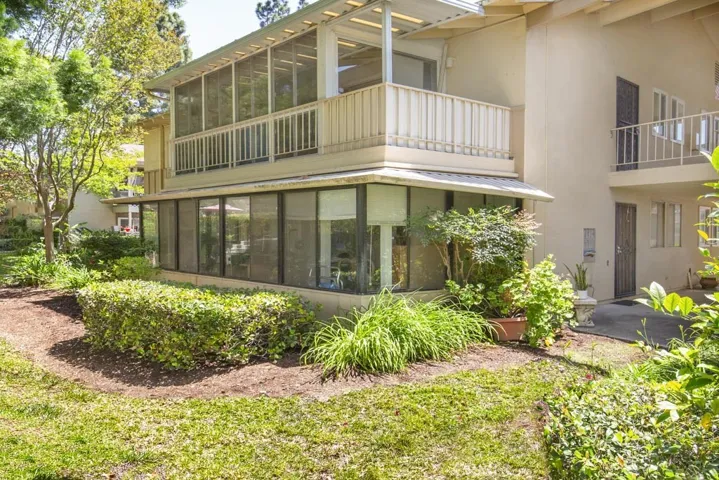 Unit "T" is the upstairs unit in this photo. The balcony has been enclosed with large glass sliders for year-round enjoyment.