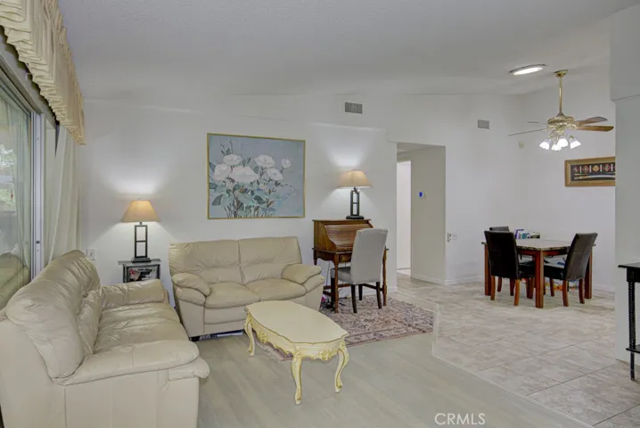 Another view of the living room. Dining area can be seen in background at right.