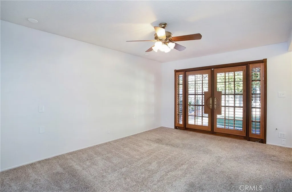 Primary bedroom with doors to backyard