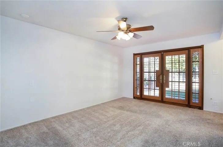 Primary bedroom with doors to backyard