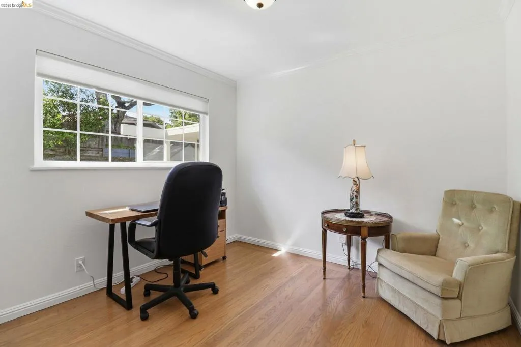 Hardwood-finish flooring complementing crisp white walls and crown molding