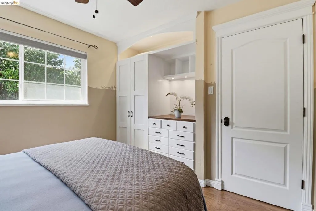 Built-in cabinetry with wood-finish countertop, under-cabinet lighting, and integrated shelving