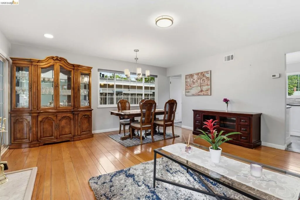 Bright interior space featuring wood-finish flooring, recessed lighting, and a modern chandelier