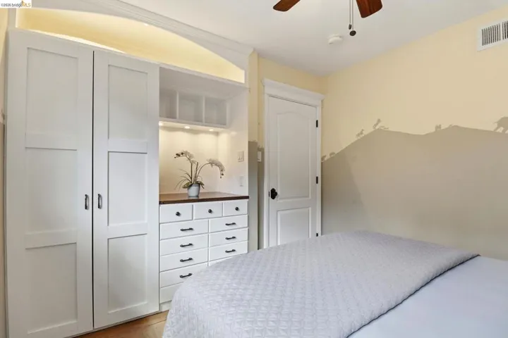 Built-in custom cabinetry with recessed lighting, integrated dresser, and upper shelving