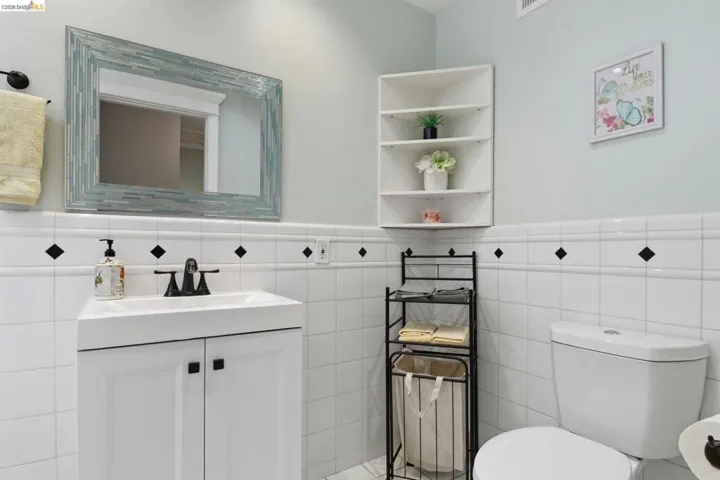 White subway tile wainscoting featuring black diamond accents