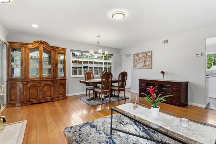 Bright interior space featuring wood-finish flooring, recessed lighting, and a modern chandelier