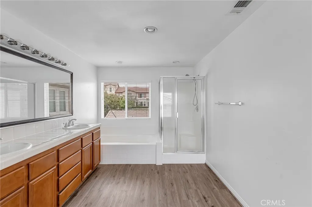 Dual vanities in Master bath, both bathtub and shower, nice flooring