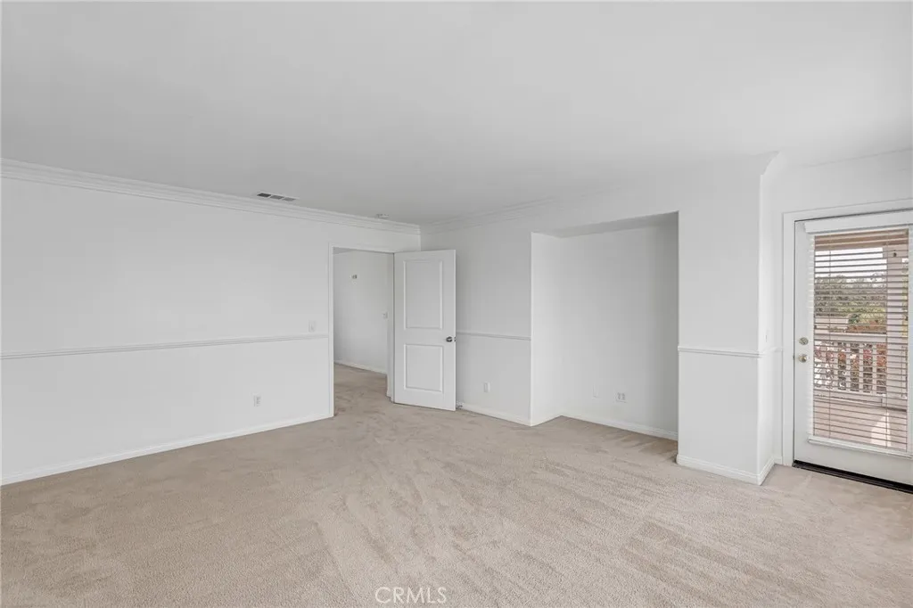 Another view inside the master bedroom and the door to a large balcony on the L